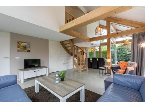 a living room with a blue couch and a table at Holiday Home near Beach Burgh-Haamstede in Burgh Haamstede