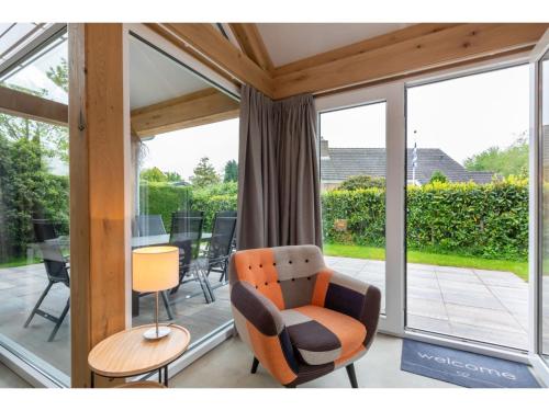 a living room with a chair and a table at Holiday Home near Beach Burgh-Haamstede in Burgh Haamstede
