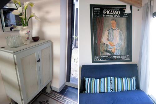 a room with a blue chair and a picture of a man at Brancadoria B&B in Monteleone Rocca Doria