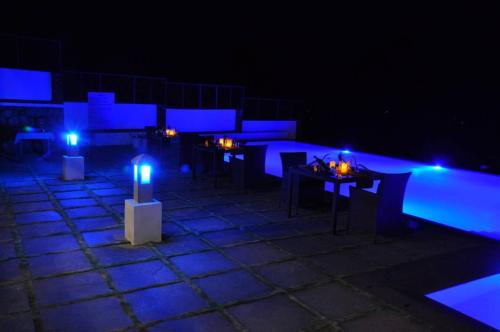 a group of tables with blue lights on them at Mountain Club Resort Munnar in Chinnakanal
