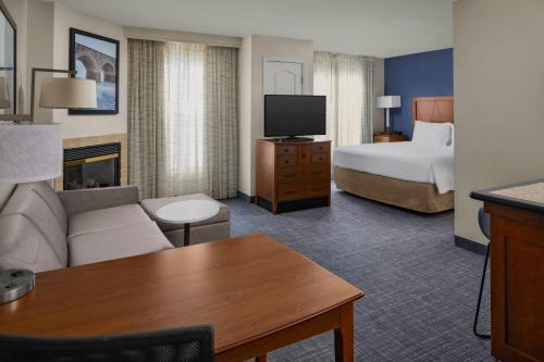 a hotel room with a couch and a bed at Residence Inn Manassas Battlefield Park in Manassas