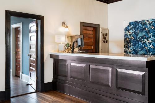 a bathroom with a counter with a sink and a mirror at Naramata Inn in Naramata