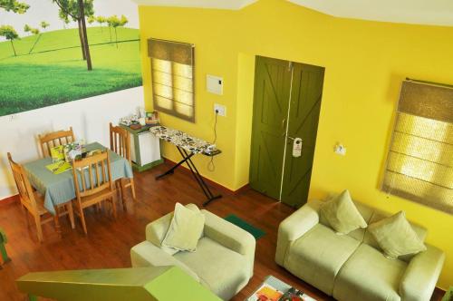 a living room with a couch and a table at Mountain Club Resort Munnar in Chinnakanal