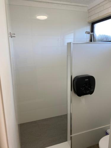 a glass shower door in a bathroom with a toilet at Tatura Country Motel in Tatura