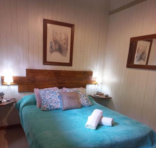 una camera da letto con un letto e due asciugamani di Casa de montaña Tierras del sur I a Villa La Angostura