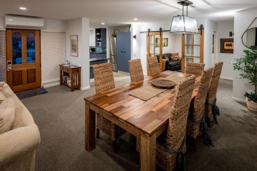 a dining room with a wooden table and chairs at Magnificent Apartment with Great Views! in Queenstown