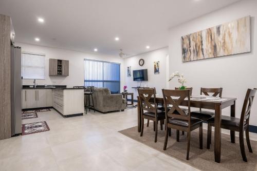 a kitchen and dining room with a table and chairs at Serenity Haven - Your Ultimate Runaway Bay Escape in Runaway Bay