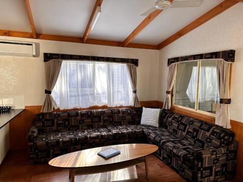 a living room with a couch and a table at Moama Riverside Holiday Park in Moama