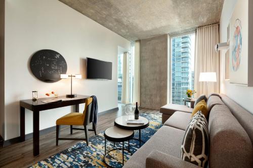 a living room with a couch and a table at Twelve Downtown, Autograph Collection in Atlanta