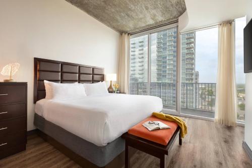 a bedroom with a large bed and a large window at Twelve Downtown, Autograph Collection in Atlanta