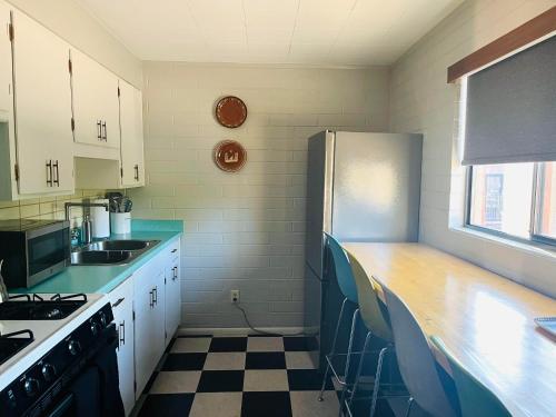 a kitchen with a counter and a refrigerator at Historic Star Motel in Sedona