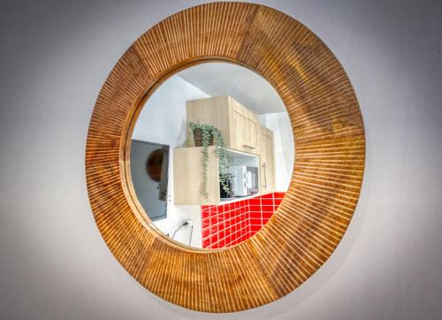 a mirror with a reflection of a kitchen in it at Le Taillefer 2 - L'Amazone in Rhut
