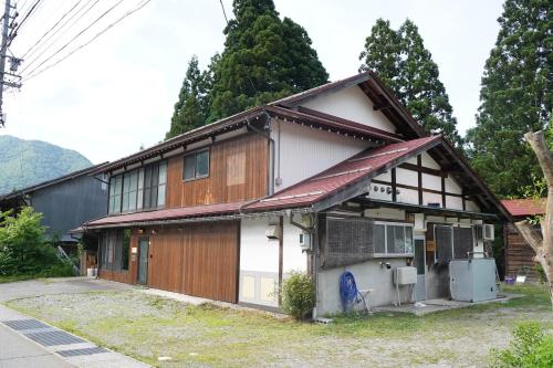 a house with a brown and white at WAY SHIRAKAWAGO - Free Parking and Newly Opened 2022 WAY SHIRAKAWAGO in Shirakawa