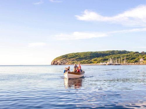 a group of people in a boat on the water at 6 person holiday home in Allinge in Allinge
