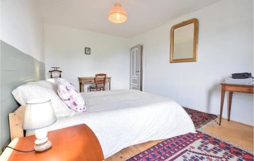 a bedroom with a bed and a table and a mirror at 3 Bedroom Amazing Home In Carrouges in Carrouges