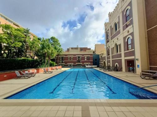 a large swimming pool in the middle of a building at Contemporary Top Floor Apartment in Sydney