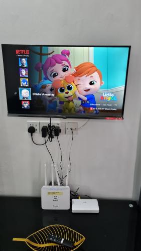 a flat screen tv sitting on top of a table at D'Lisha Homestay Changlun/Bukit Kayu Hitam/Sintok in Changlun
