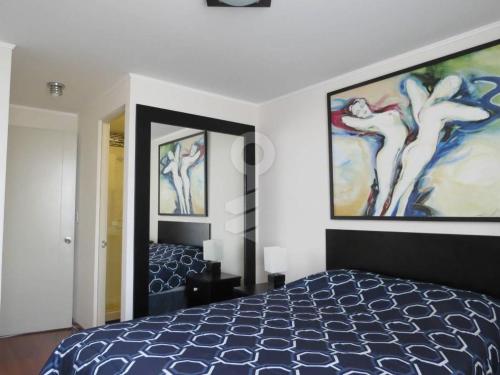 a bedroom with a bed and a painting on the wall at Temporal Apartment in Lima