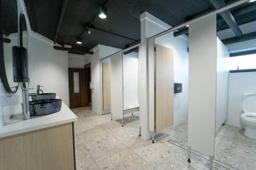 a bathroom with a toilet and a sink and mirrors at Spectacular Central Surfers Beach Views from Apartment in Gold Coast