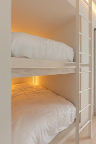 a white bunk bed in a small room at kamosu mori in Tokamachi