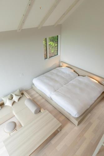 a bedroom with a bed and two tables at kamosu mori in Tokamachi