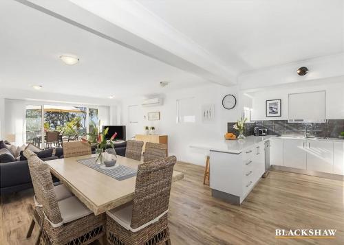 a kitchen and living room with a table and chairs at Seaview by the Cliff in Surf Beach