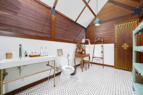 a bathroom with a toilet and a sink at Villa Atra Bambulogy by Nagisa Bali in Kerobokan