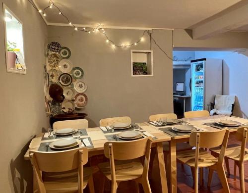 a dining room table with chairs and plates on it at 4Bs - Birds & Bicycles in Castro Verde