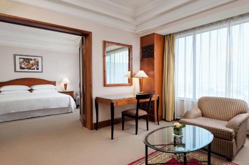 a hotel room with a bed and a desk at Sheraton Xi'an Hotel in Xi'an