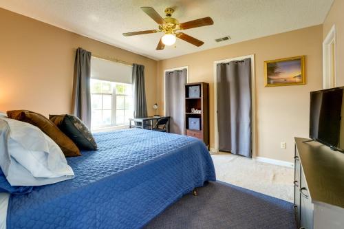 a bedroom with a blue bed and a ceiling fan at Horn Lake Vacation Rental about 14 Mi to Memphis! in Horn Lake