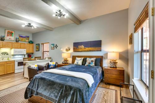 a bedroom with a bed and a kitchen at Angel Fire Studio with Fireplace, Walk to Resort! in Angel Fire
