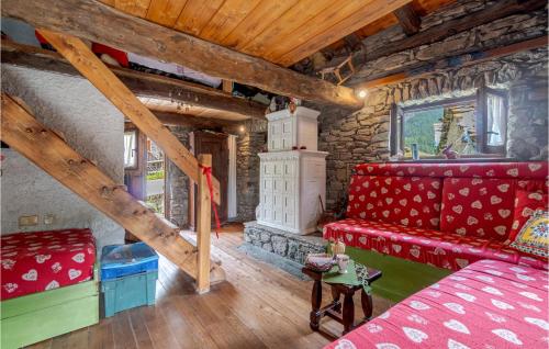 a living room with a red couch and wooden ceilings at Casa Del Pepe in Chamois