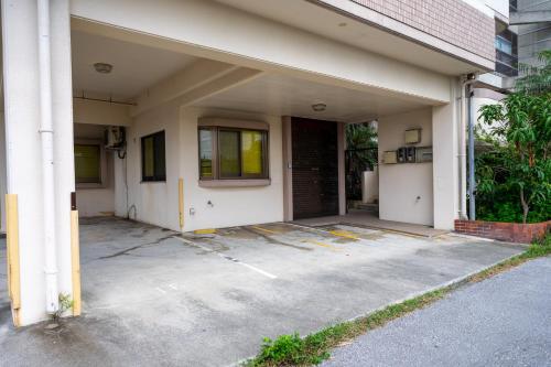 an empty parking lot in front of a building at Wing Mihama in Chatan