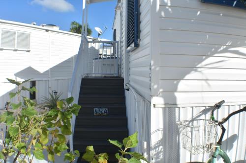 a stairway leading up to a white building at Pelican's Roost, Waterfront comfort at Venture Out in Cudjoe Key