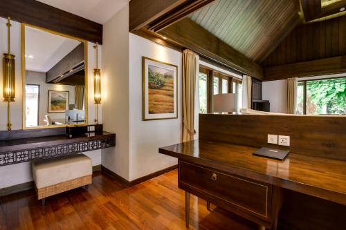 a home office with a desk and a mirror at The Samaya Ubud in Ubud