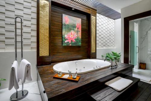 a bathroom with a large tub in a room at The Samaya Ubud in Ubud
