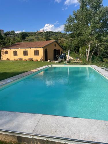 a swimming pool in front of a house at Luxury Country Villa Daniele in Poggio Sommavilla