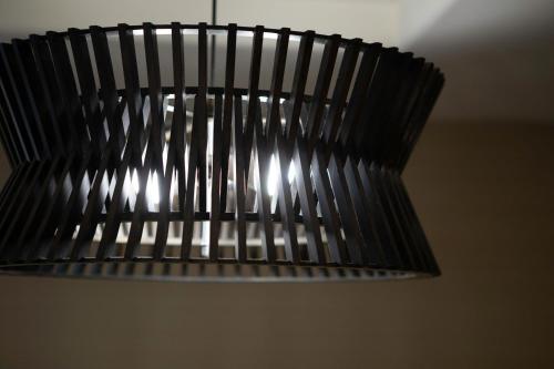 a black light fixture hanging from a ceiling at Courtyard by Marriott San Diego Del Mar/Solana Beach in Solana Beach