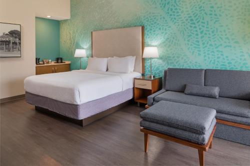 a hotel room with a bed and a couch at Courtyard by Marriott San Diego Del Mar/Solana Beach in Solana Beach