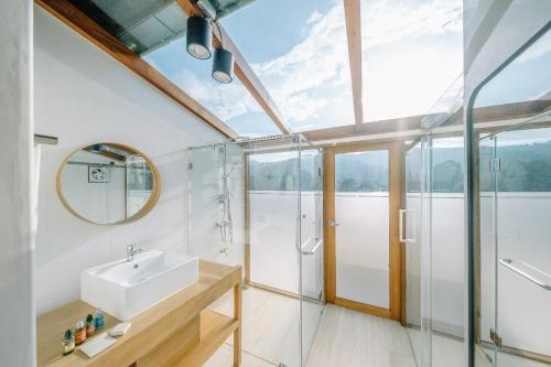 a bathroom with a glass shower and a sink at 108 Villa @ PongYang in Chiang Mai