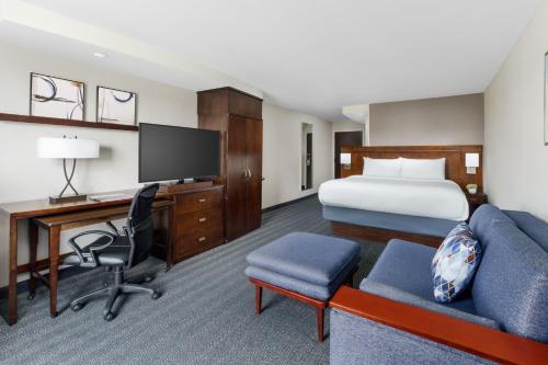 a hotel room with a bed and a desk at Courtyard Keene Downtown in Keene