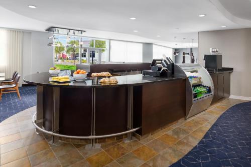 a kitchen with a large island with food on it at Courtyard Keene Downtown in Keene