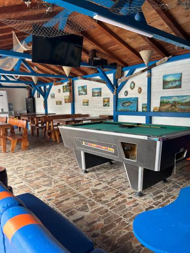 a ping pong table in a room with a pool table at Casa Iris Murighiol in Murighiol