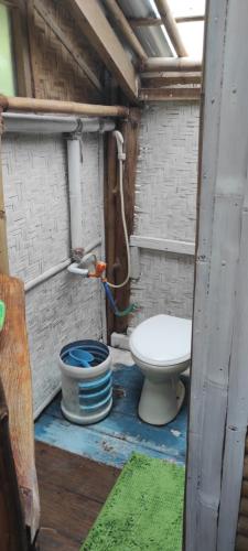 a bathroom with a toilet in a building at Bamboo hut Alpha Hotel in Maluk