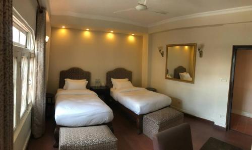 Letto o letti in una camera di Courtyard Pujan Hotel
