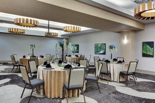 a conference room with tables and chairs and chandeliers at Crowne Plaza Hotel & Resorts Fort Lauderdale Airport/ Cruise by IHG in Fort Lauderdale