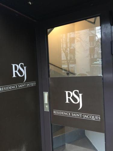 a glass door with a rst sign on it at Studio Montsouris in Paris