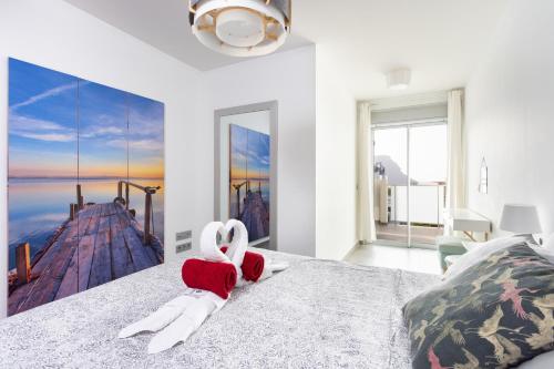 a bedroom with a stuffed swan on a bed at Apartamentos Las Terrazas de Sotavento in La Mareta