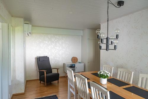 a dining room with a table and a chair at Omakotitalo keskustan lähellä in Joensuu