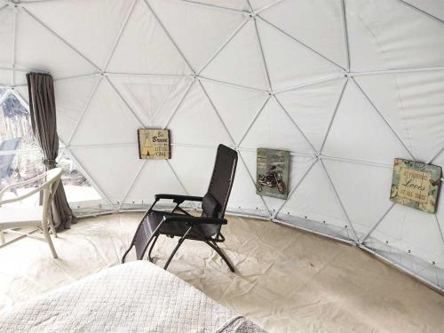 a room with a chair in a dome tent at Eco Glamping Treehouses Closest Resort To All Tourist Attractions in Balilihan